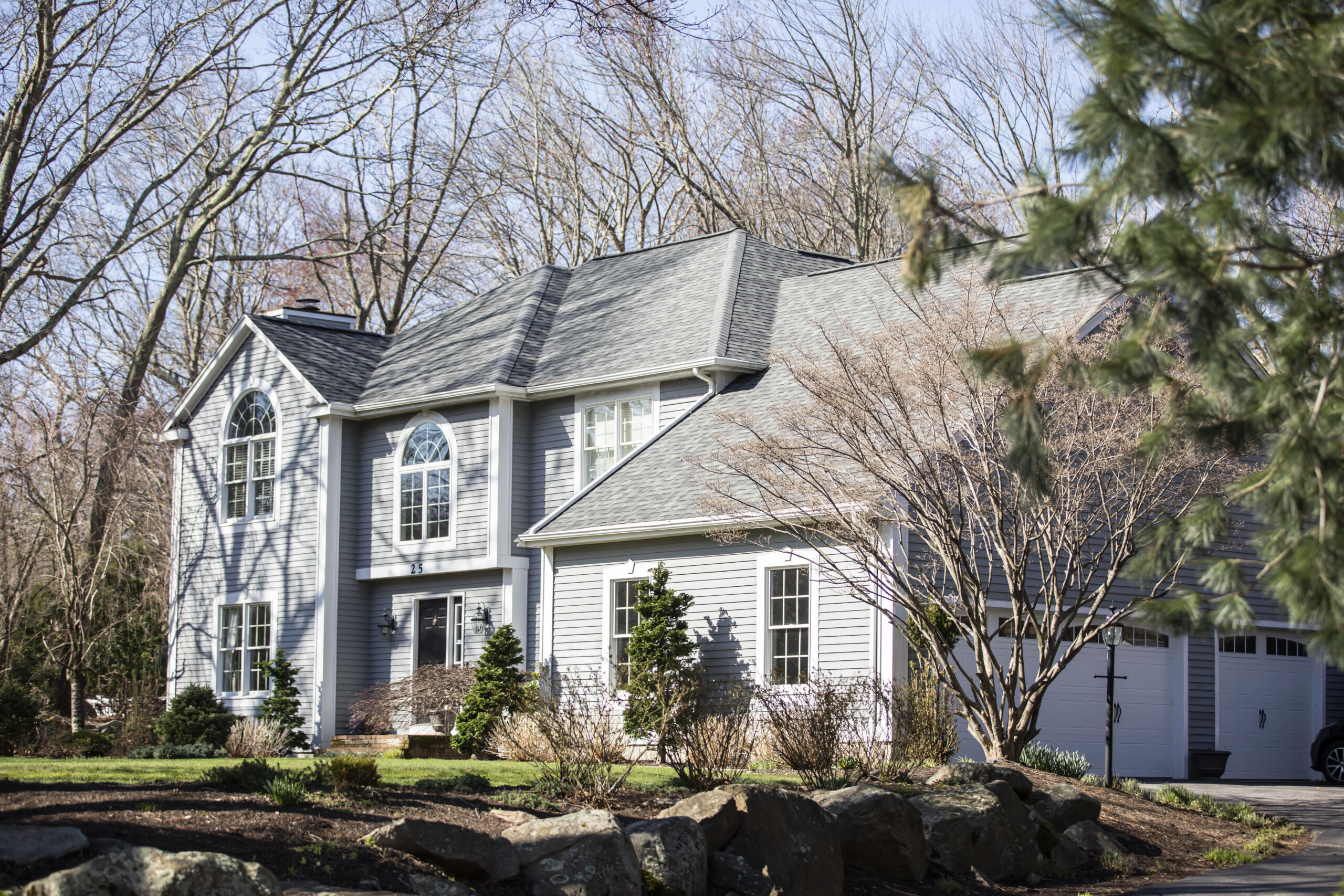 a large home with a brand new roof courtesy of AEM
