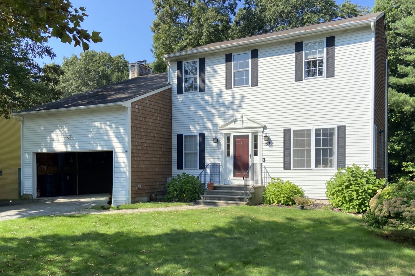 Rhode Island home exterior before AEM renovation showing old siding and lack of deck or outdoor entertainment area