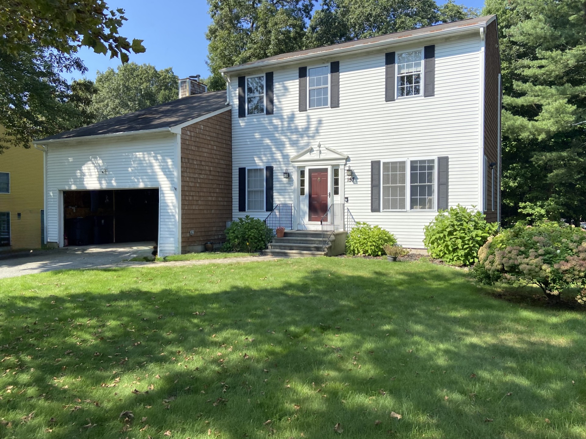 Rhode Island home exterior before AEM renovation showing old siding and lack of deck or outdoor entertainment area